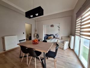 a living room with a wooden table and chairs at Charmanta 23 in Nafplio