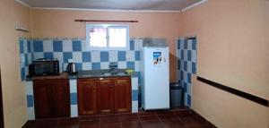 a small kitchen with a refrigerator and a window at Pucará in Federación