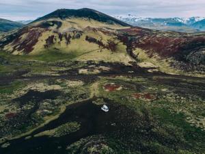 an aerial view of a mountain with a house on it at Rent Campervans in Keflavík