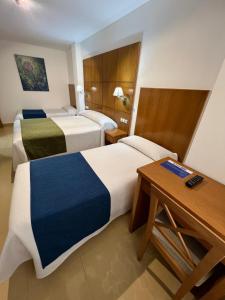 Hotel Tio Pepe في بينييسكولا: غرفة فندقية بسريرين ومكتب