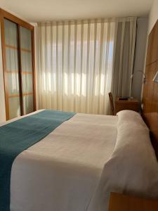 Postel nebo postele na pokoji v ubytování Hotel Tio Pepe