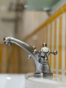 a bathroom sink with a faucet on a sink at Hotel Tio Pepe in Peñíscola