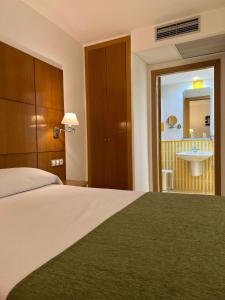 Postel nebo postele na pokoji v ubytování Hotel Tio Pepe