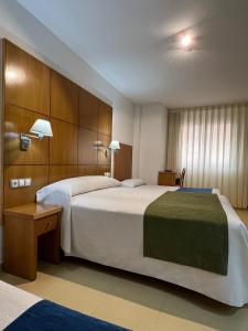 Postel nebo postele na pokoji v ubytování Hotel Tio Pepe