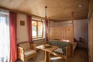 a living room with a table and a couch at Haus Sonnblick in Abtenau