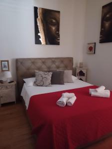 a bedroom with a bed with two slippers on it at Le Stanze di Penelope in Salerno