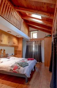 a bedroom with a bed in a room with wooden ceilings at Chalet vista Monte Bianco in La Salle