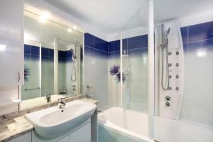 a white bathroom with a sink and a shower at Chalet vista Monte Bianco in La Salle