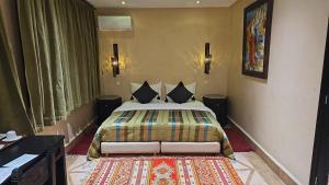 a bedroom with a large bed in a room at Riad Dar Haven in Tamraght Ou Fella