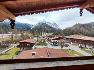 una ventana con vistas a una ciudad con montañas en Hotel Gut Kramerhof en Kirchdorf in Tirol