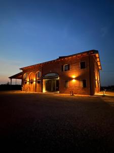 a brick building with lights on it at night at La Cascina del Balsamico in Gaggio