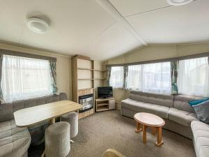 a living room with a couch and a table at Great Caravan For Hire By The Beach In Norfolk, By Hunstanton Beach Ref 13005l in Hunstanton