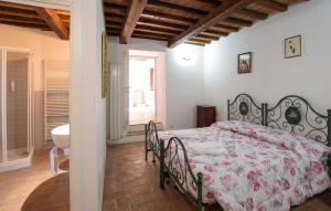 a bedroom with a large bed and a bathroom at 1 Bedroom Nice Apartment In Gubbio in Gubbio