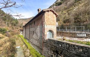 a brick building on the side of a mountain at 1 Bedroom Nice Apartment In Gubbio in Gubbio