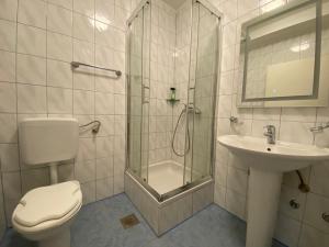 a bathroom with a toilet and a sink and a shower at Motel Vujeva in Livno