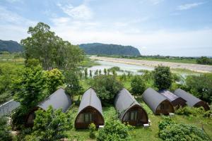 an aerial view of a row of cottages next to a river at Khách sạn AQUARIUS GARDEN VÂN LONG NINH BÌNH in Ninh Binh