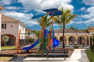 a playground with a slide and an umbrella at The Orchid Townhouse! 2B/2.5B in Miami Gardens