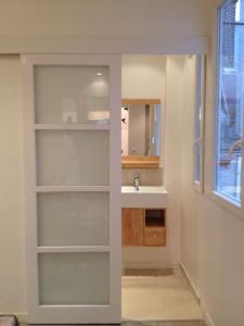 a bathroom with a sink and a white shelf at Luxury studio in 5 minutes of the Champs-Elysées in Paris