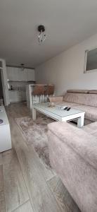 a living room with a couch and a table at Apartman-Stan in Bugojno