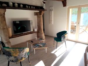 a living room with two chairs and a tv at Maison de 3 chambres avec jardin clos et wifi a Offranville a 4 km de la plage in Offranville