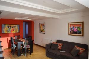 a living room with a couch and a table at Los Perales in San Salvador de Jujuy