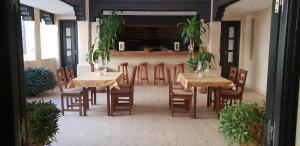 a dining room with tables and chairs and plants at Riad Dar Haven in Tamraght Ou Fella
