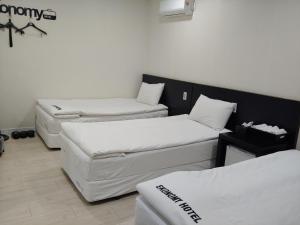 a room with three mattresses in a room at Ekonomy Hotel in Gumi