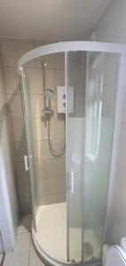 a shower with a glass door in a bathroom at Studio with Private Kitchen in Dublin