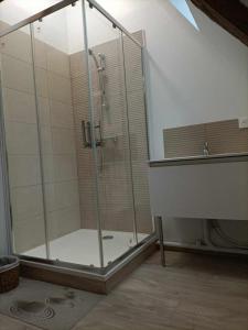 a shower with a glass door in a bathroom at Maison charmante à Offranville avec grand jardin in Offranville +92 photos
