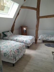 a bedroom with two beds and a window at Maison de 3 chambres avec jardin clos et wifi a Offranville a 4 km de la plage in Offranville