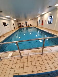 a large swimming pool in a building at 22 Washbrook Way in Ashbourne