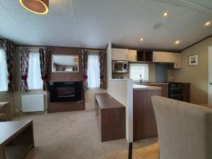 an open kitchen and living room with a table at 22 Washbrook Way in Ashbourne