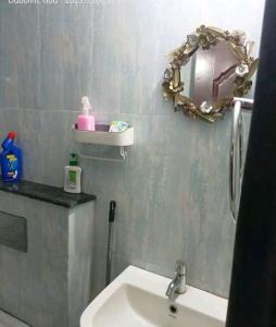a bathroom with a sink and a mirror at 2 BHK SKY water Apartment(SKY 2) in Marmagao