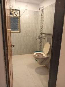 a bathroom with a toilet and a shower in a room at 2 BHK SKY water Apartment(SKY 2) in Marmagao