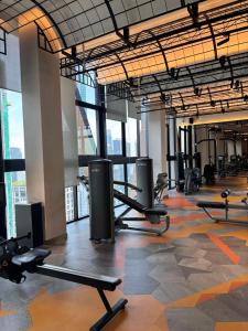 a gym with rows of tread machines in a building at Scarletz Comfy Suites KLCC by MOMO in Kuala Lumpur