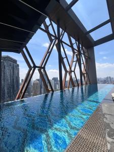 a swimming pool on the roof of a building with a view at Scarletz Comfy Suites KLCC by MOMO in Kuala Lumpur