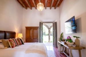 a bedroom with a bed and an open door at Hotel Boutique Viñedo Los Remedios in San Miguel de Allende +42 photos