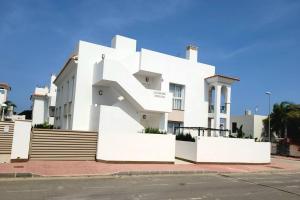 a white building with a large letter on it at Casa Marietha Apartment with swimming pool and roof terrace in Rojales