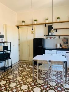 a kitchen with a table and chairs in a kitchen at Vista sul porto Ortigia in Syracuse