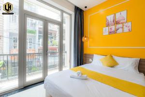a bedroom with a bed and a large window at Luxury Condotel Sai Gon 2 in Ho Chi Minh City