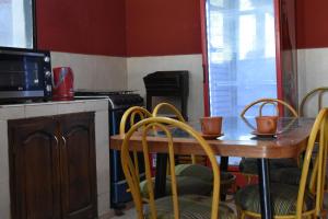 uma cozinha com uma mesa, cadeiras e um fogão em La Rosarito em Humahuaca