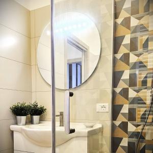 a bathroom with a toilet and a mirror at BBking Appartamento Policlinico San Donato Milanese in San Donato Milanese +23 photos