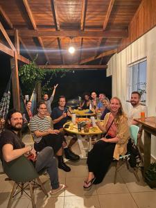 a group of people sitting around a table at Nômades Adventure Hostel & Coworking in Florianópolis