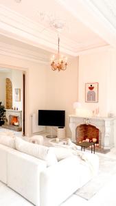 a living room with a white couch and a fireplace at Unique Mansion RL in Antwerp