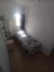 a small room with a bed in the corner at La Casita in Tecka