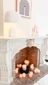 a fireplace with some candles on top of it at Unique Mansion RL in Antwerp