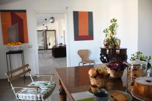 a dining room with a table with fruit on it at Thesan B&B in San Prisco +47 photos