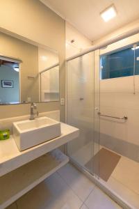 een badkamer met een wastafel en een douche bij Pousada Vila do Porto in Paraty