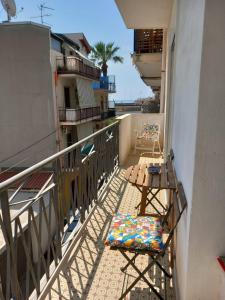 a balcony with a table and chairs on a balcony at MareFuori in Giardini Naxos