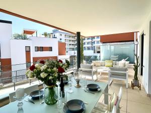a table with a vase of flowers on a balcony at Paradise in Fuengirola in Fuengirola